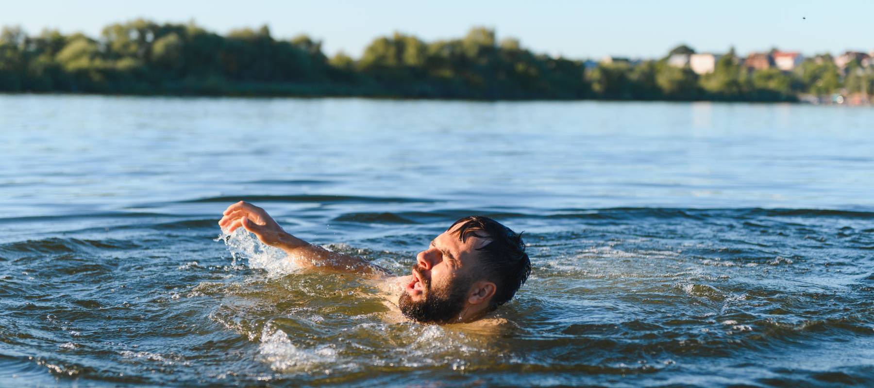 A man flails for his life in remarkably still water. How did he get there if he can't swim? We just don't know.