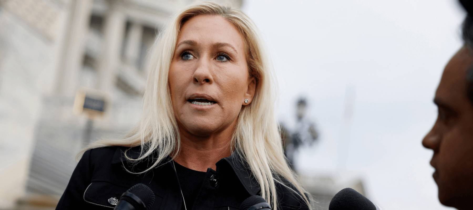 Marjorie Taylor Greene speaks to reporters.