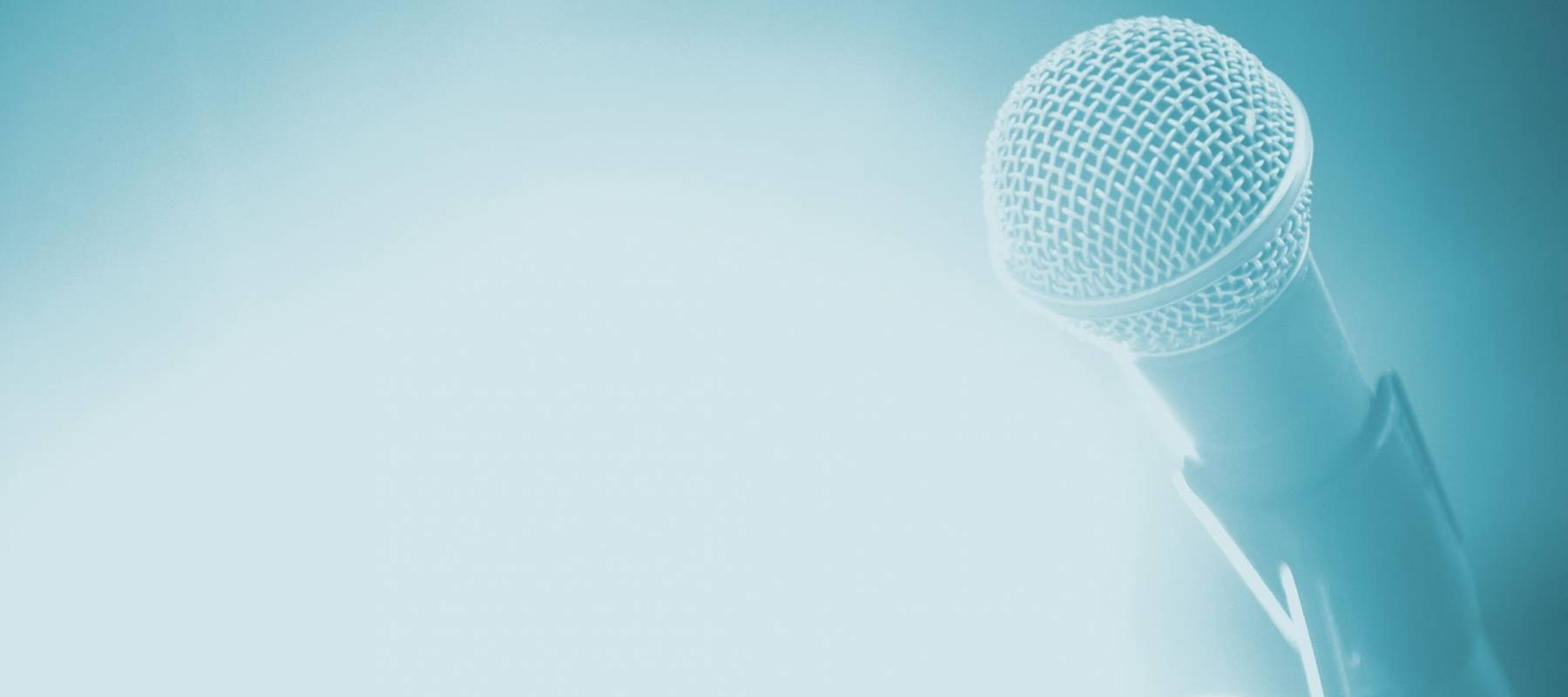 Microphone on stage with shiny rays as the background