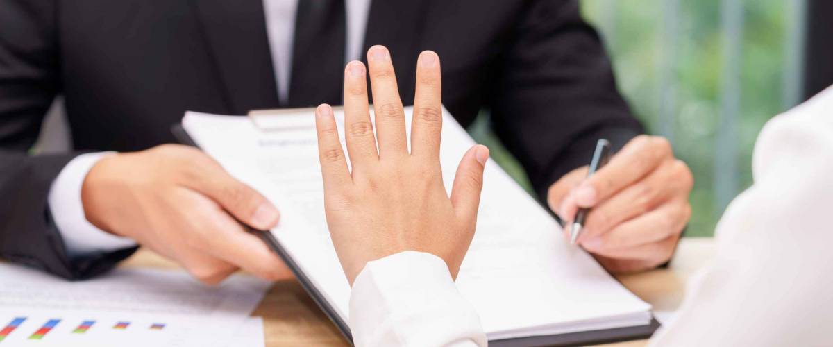 Customer or woman says no or hold on when businessman giving pen for signing a contract.