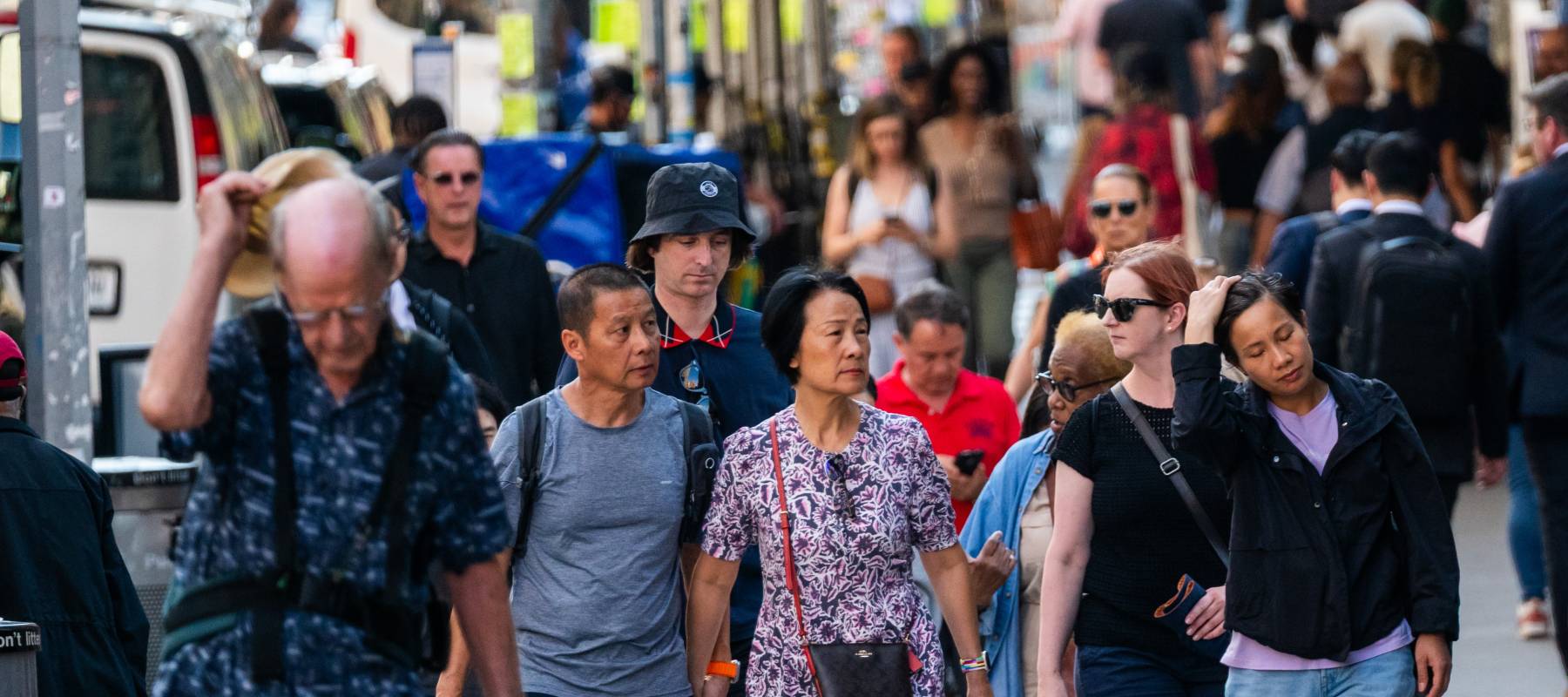 A group of new yorkers walk down a street.