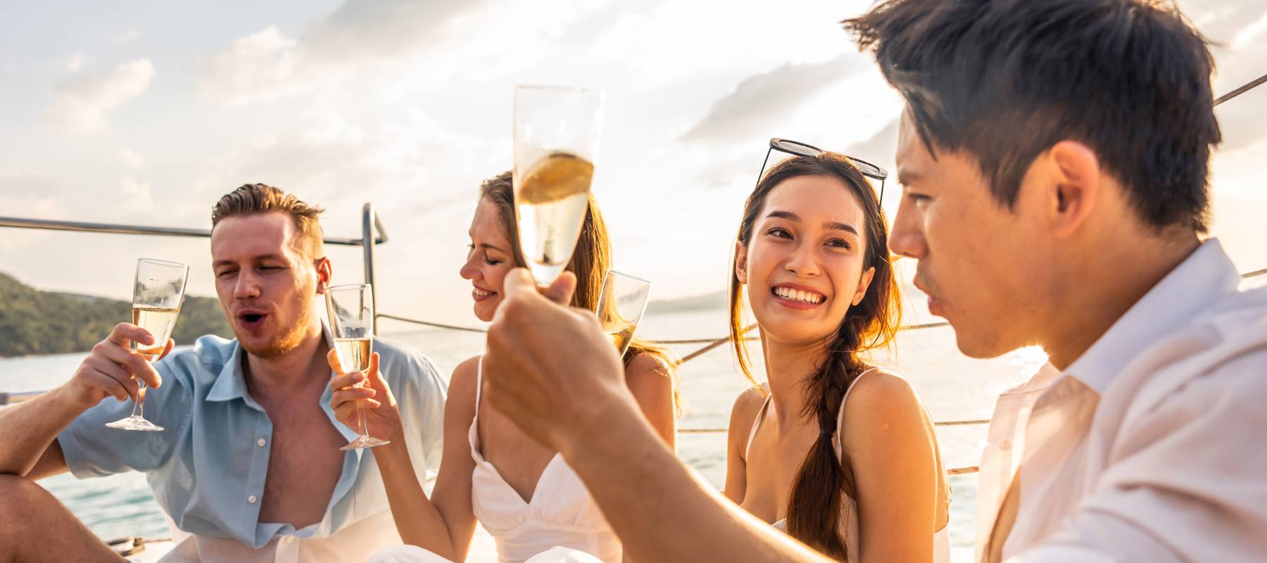 group of diverse friends drink champagne while having a party in yacht