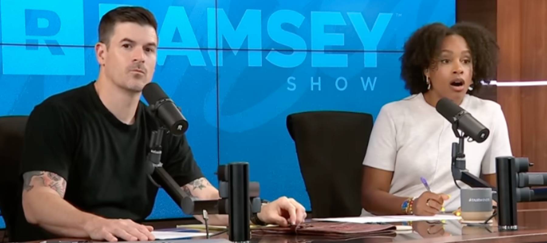 Ramsey Show cohosts John Delony and Jade Warshaw listening to a caller.