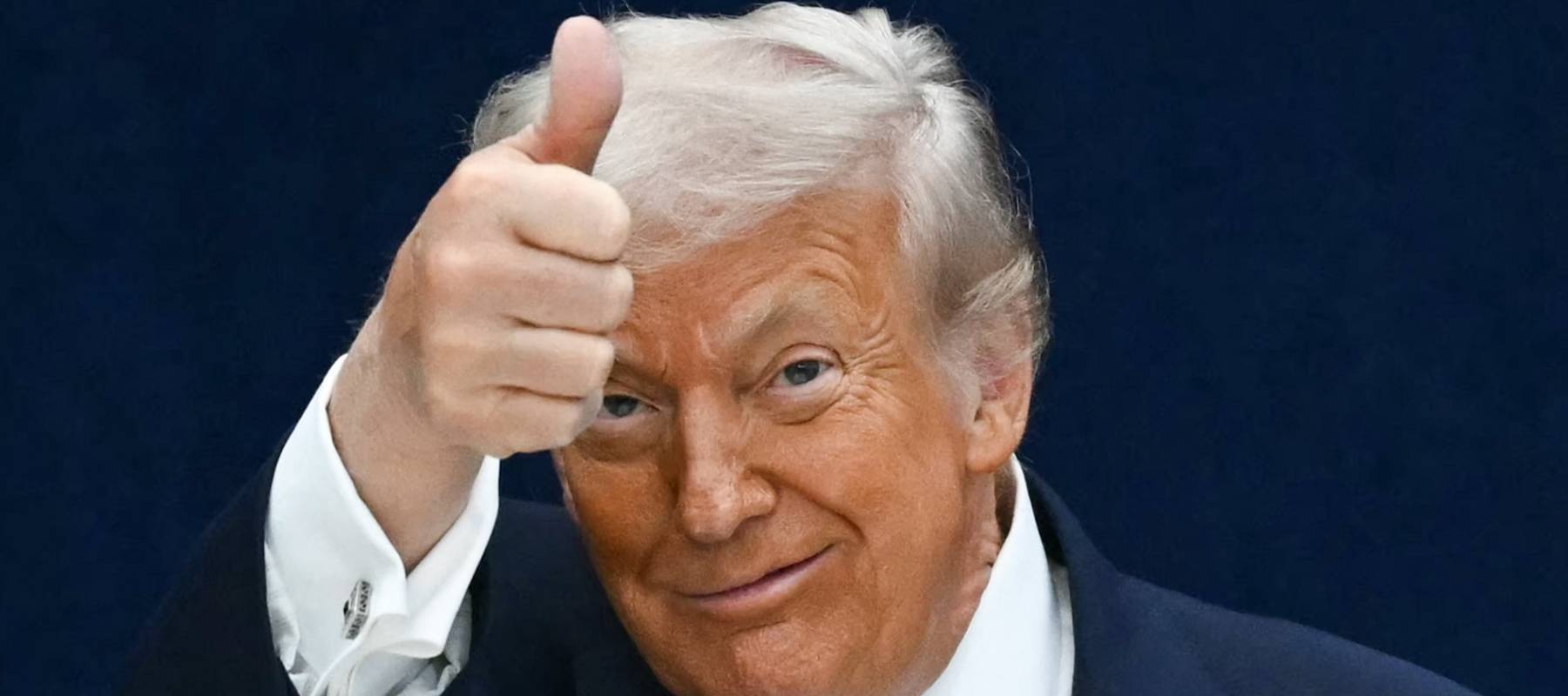 US President Donald Trump gives a thumbs up as he departs the stage during the signing ceremony of a peace deal.