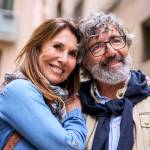Retired happy couple looking out at a beautiful vista during a trip to a possible European destination, such as Italy.