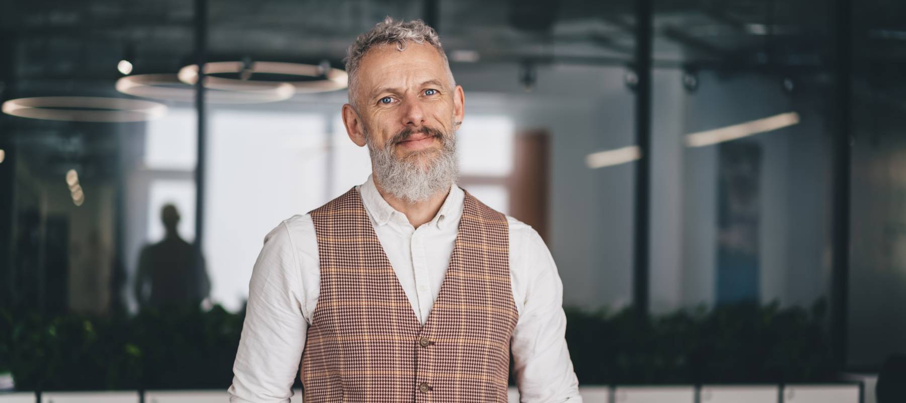 confident Caucasian middle-aged man standing in office room