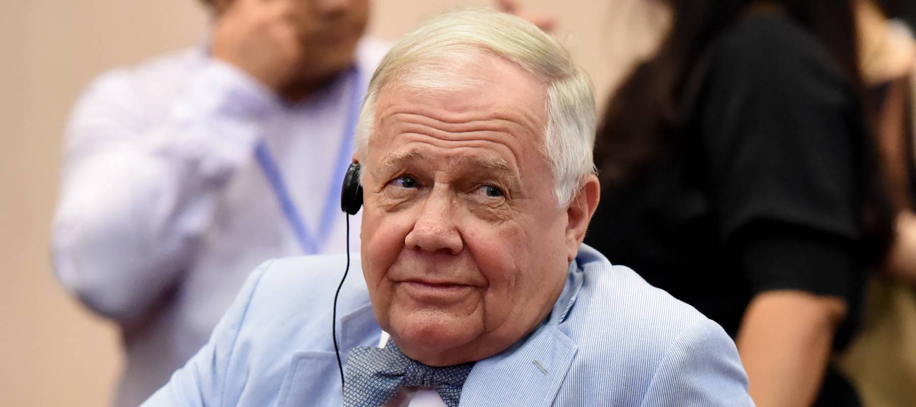 Jim Rogers, wearing a robin's egg blue suit jacket and matching bow tie, raises his eyes in skepticism.