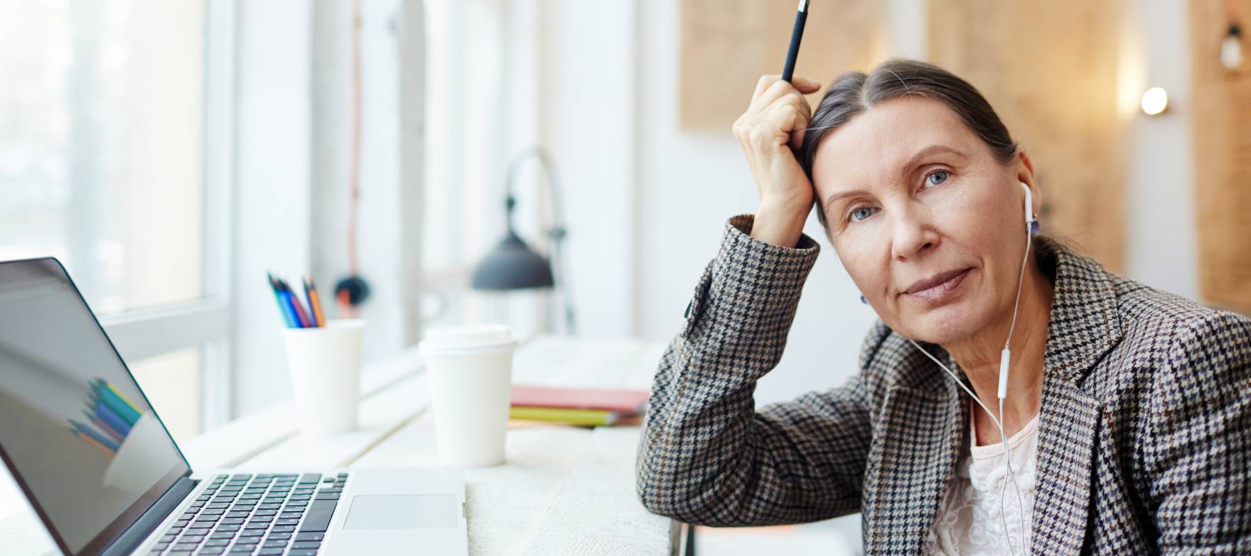 a woman in her 50s in an office an environment looking at the camera