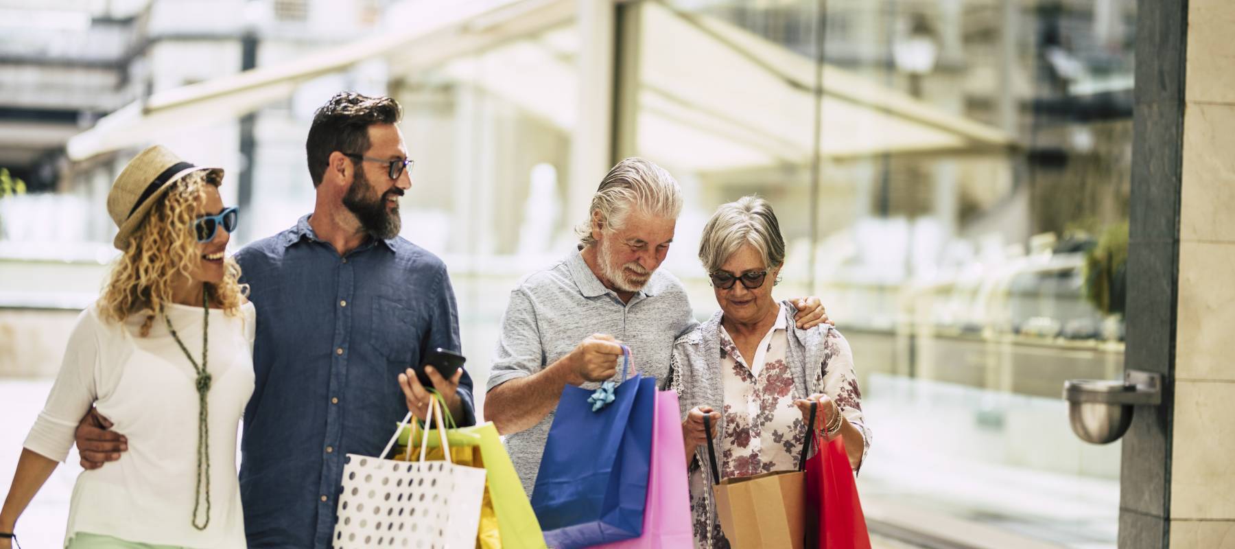group of people go shopping together with a lot of bags on their arms