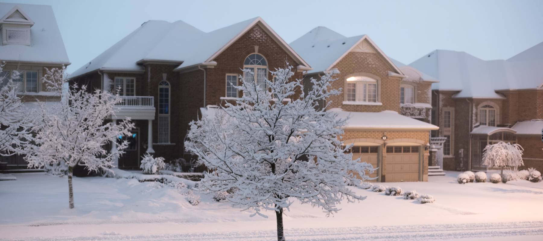 Suburban street covered in snow.