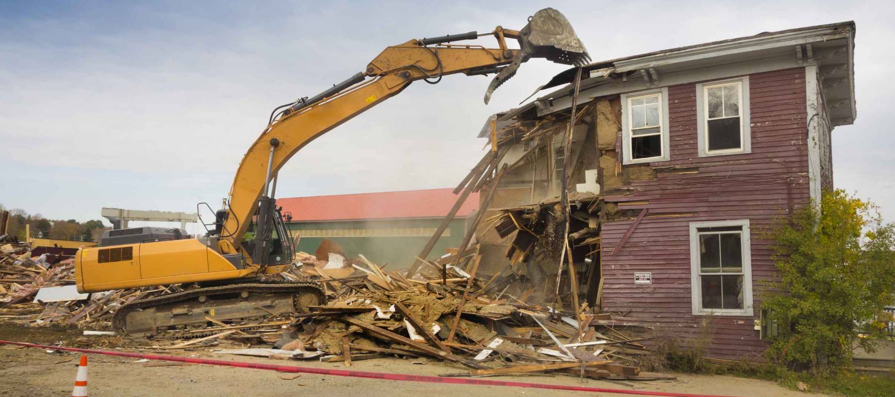 A digger demolishing a house for reconstruction.