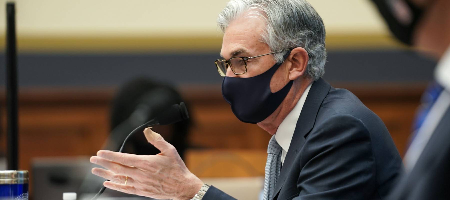 Fed Chairman Jerome Powell wearing mask speaks into microphone