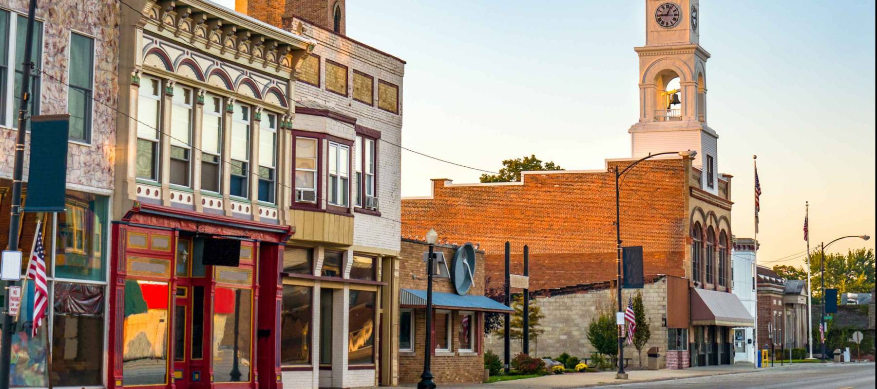 Traditional main street of quaint USA small town with storefronts and clock tower