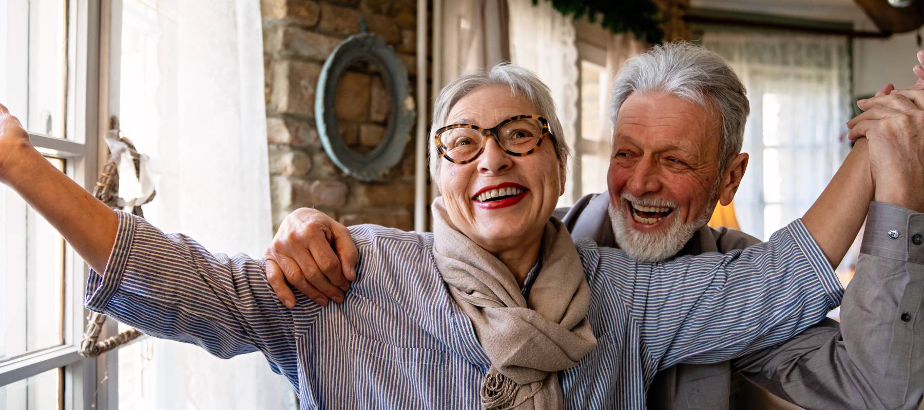 senior couple, happy, in their home
