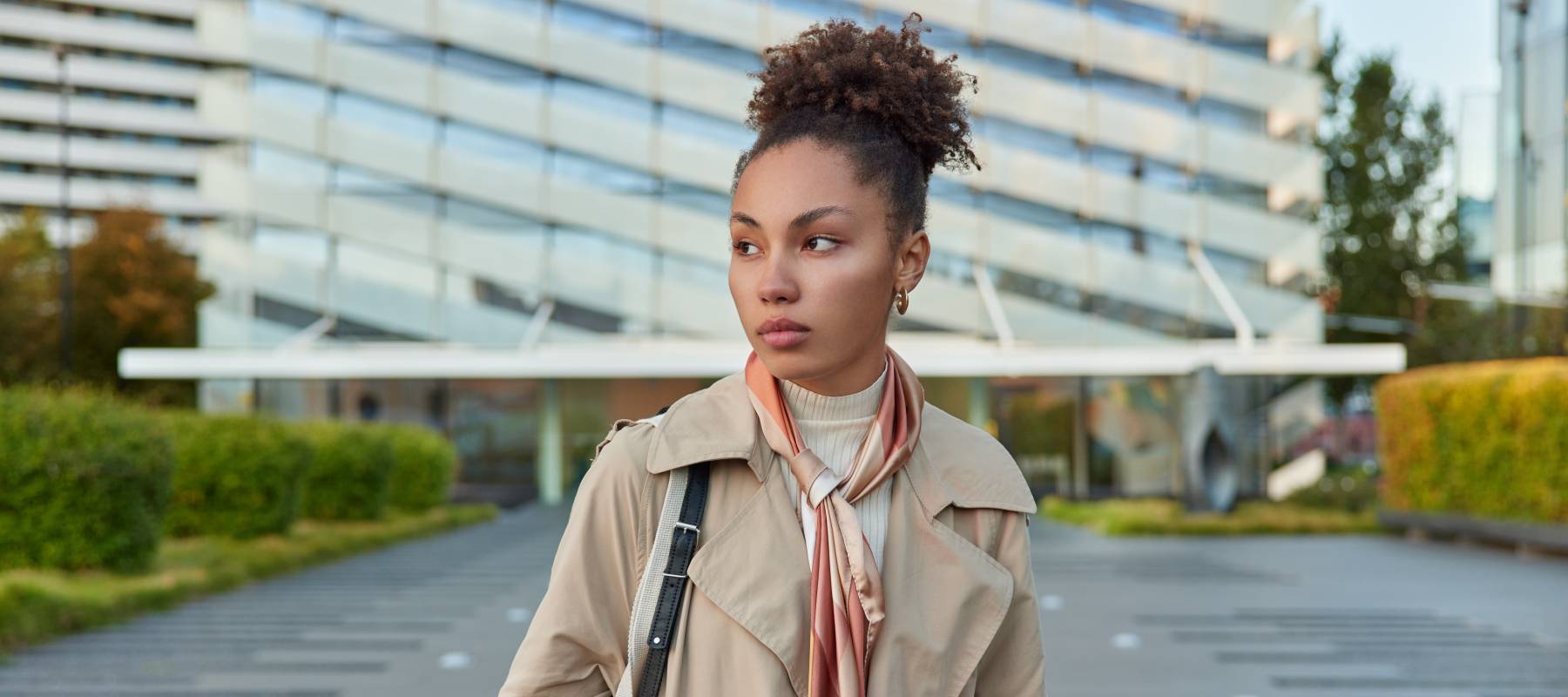 concerned-looking Black woman walking down a city street