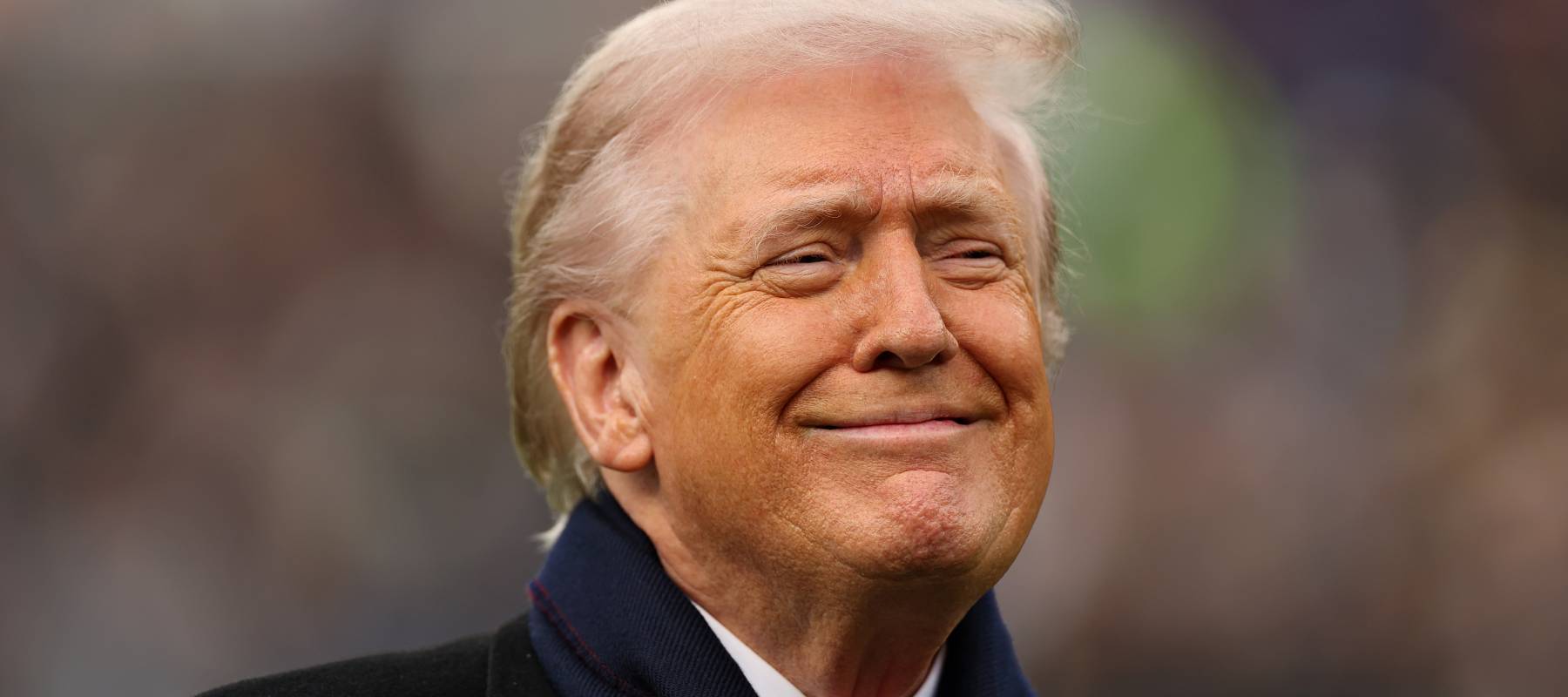 U.S. President Donald Trump smiles from the field before the 126th America's Game between the Army Black Knights and the Navy Midshipmen at M&T Bank Stadium on December 13, 2025.