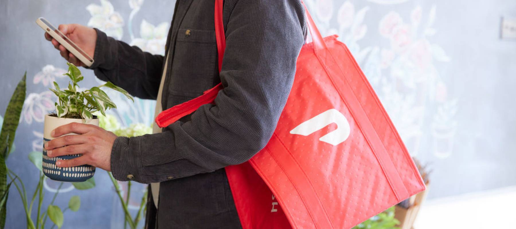 a person demonstrates making a delivery with DoorDash as a Dasher