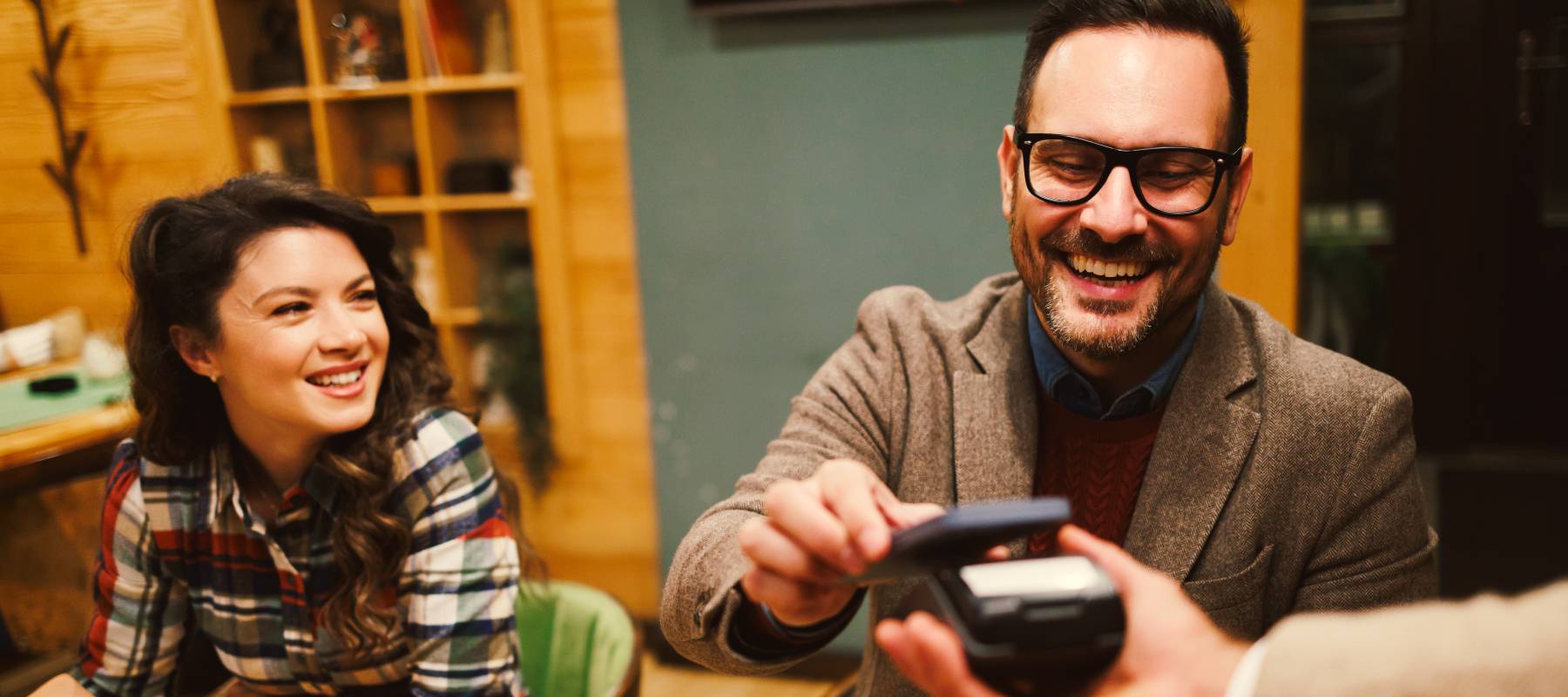 A man paying the bill at a restaurant.