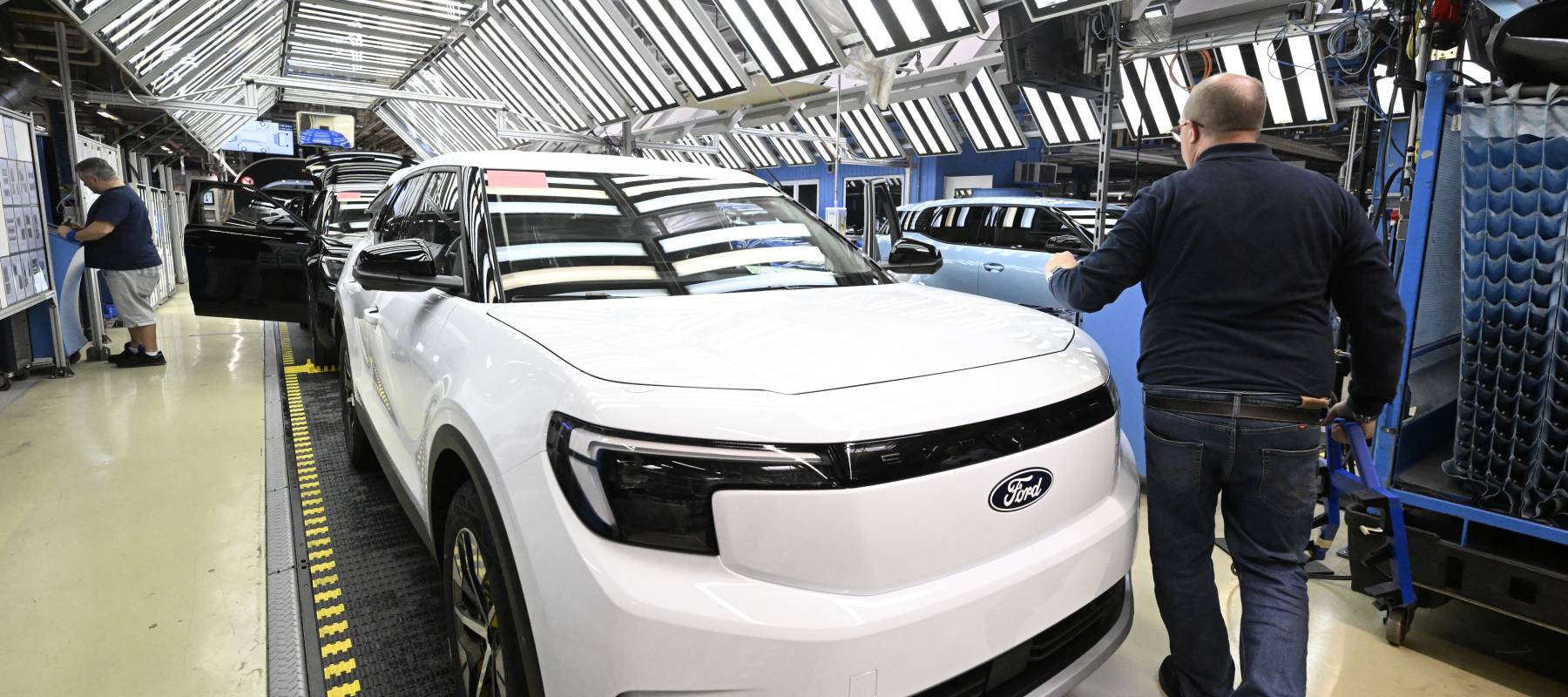 Employees work on the production line of the 100% electric Ford Explorer at the Ford Electric Center Factory in Cologne, Germany, June 4, 2024.