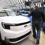Employees work on the production line of the 100% electric Ford Explorer at the Ford Electric Center Factory in Cologne, Germany, June 4, 2024.