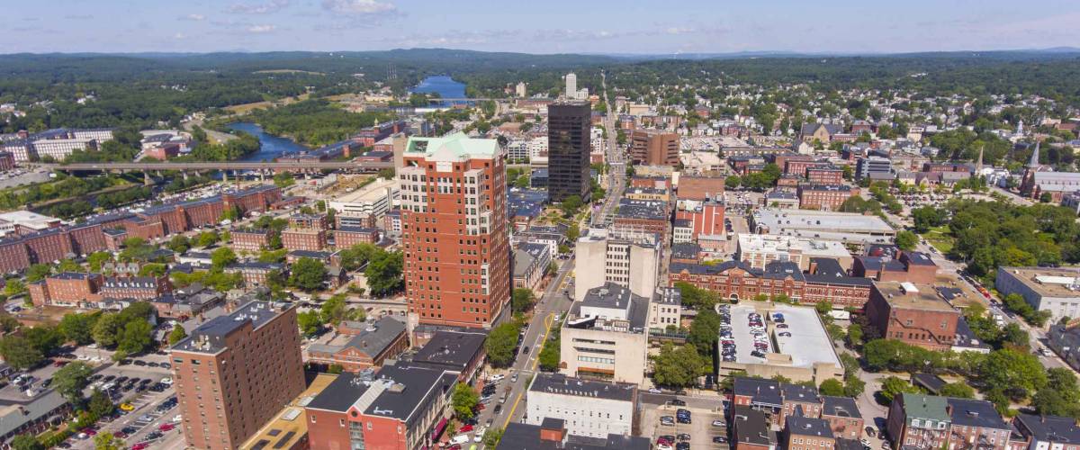 Manchester downtown building including City Hall Plaza and Brady Sullivan Plaza with Merrimack River at the background aerial view, Manchester, New Hampshire, NH, USA.