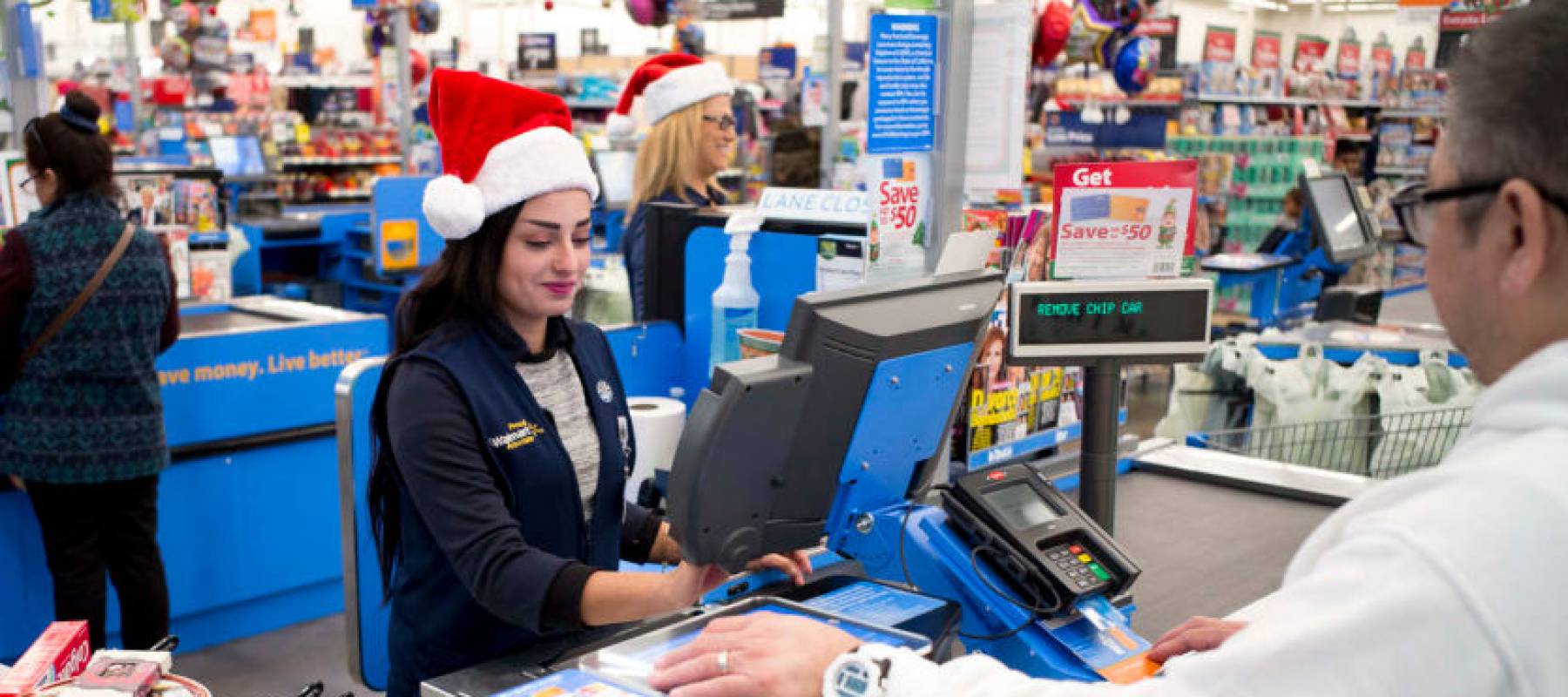 A Walmart employee cashes out a customer in Burbank, California.