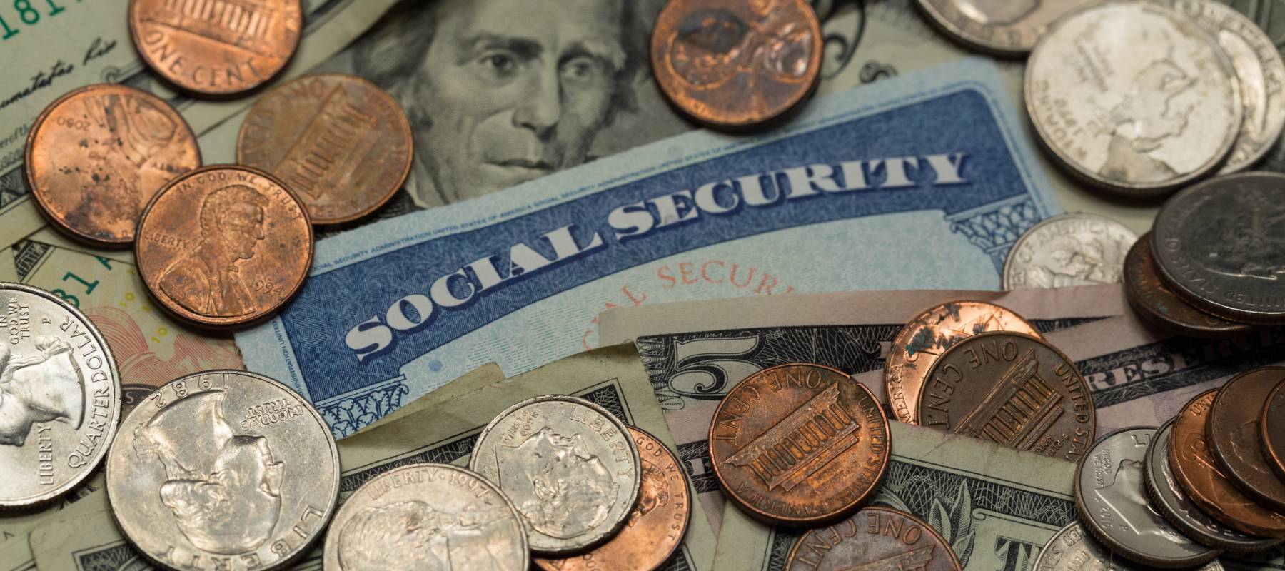 A blue Social Security card with dollars and coins.
