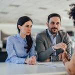 Man and woman negotiate rate at car dealership
