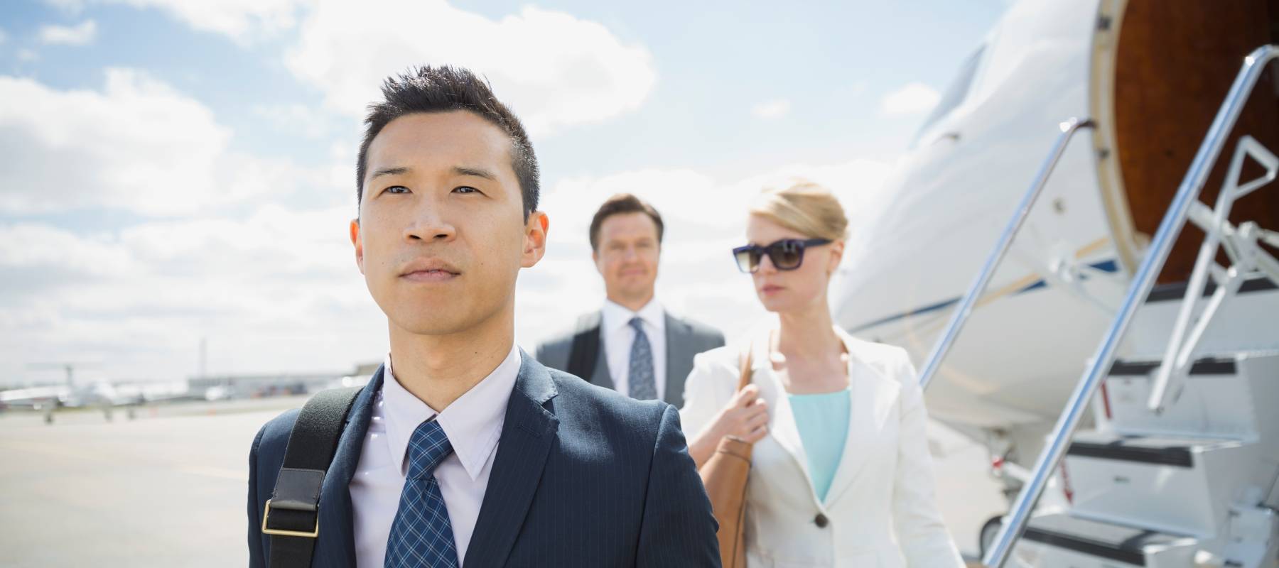 wealthy people taking a private jet