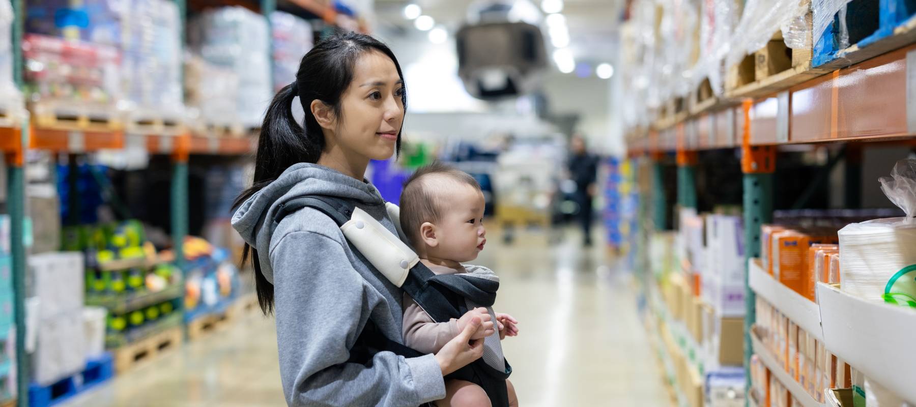 Asian mother with baby in shopping store