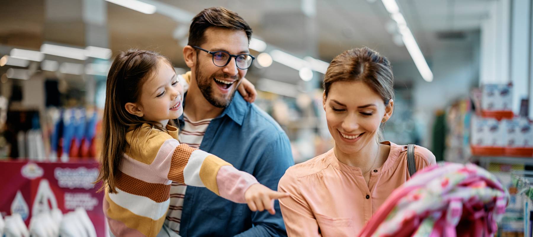 a young Caucasian family shopping for school supplies