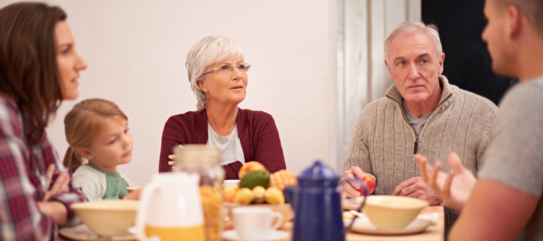 Family discusses serious news at the dinner table.