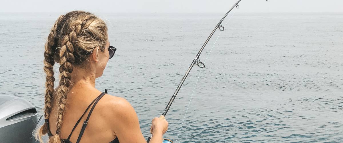 woman in a boat fishing