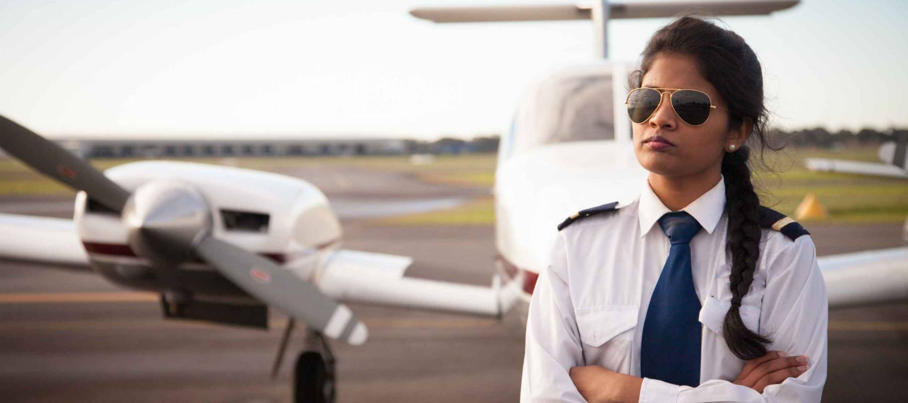 Female Pilot by Her Aircraft