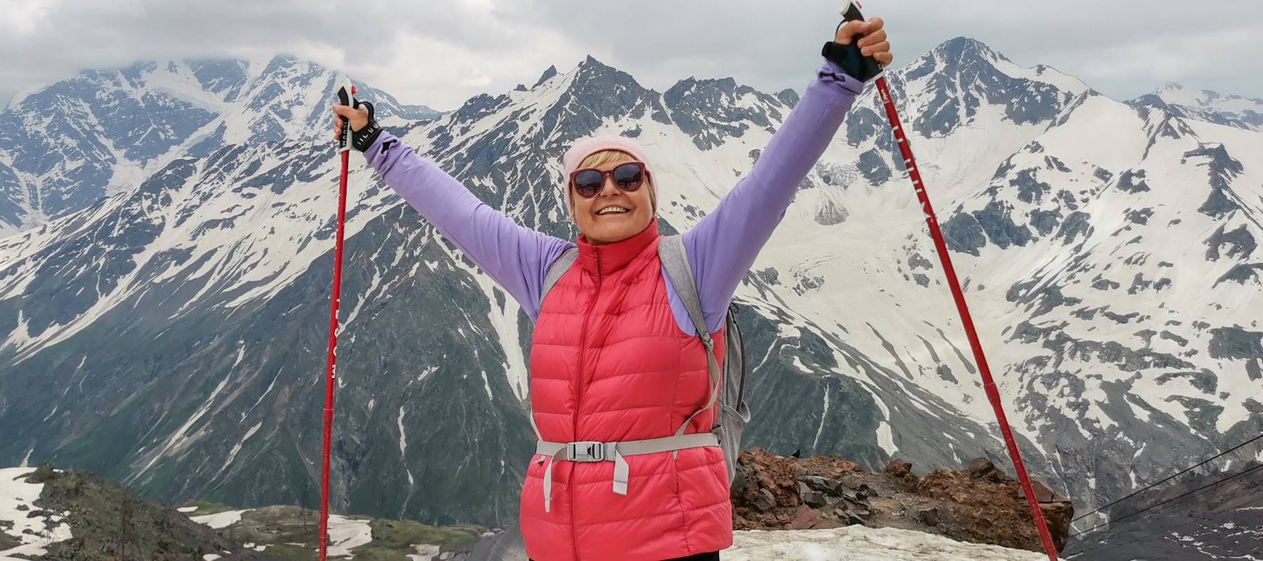 Woman on top of a mountain.