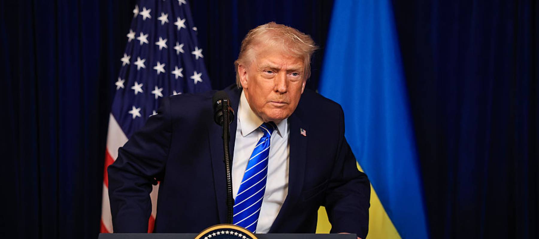 U.S. President Donald Trump listens to a question from a reporter during a press conference
