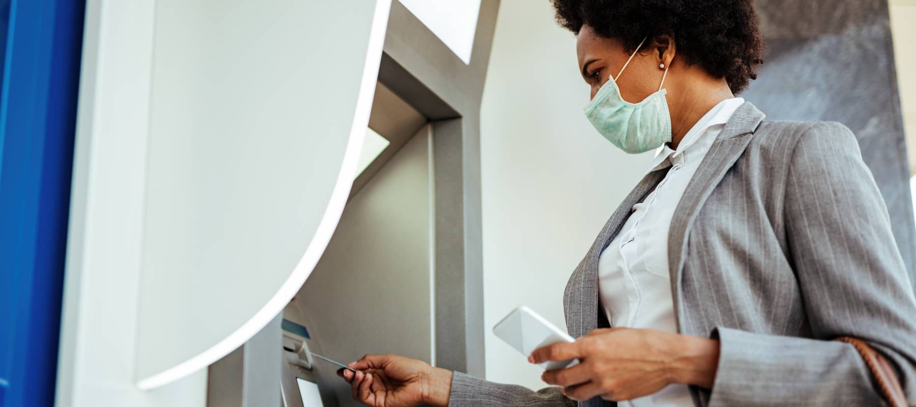 Masked woman at ATM
