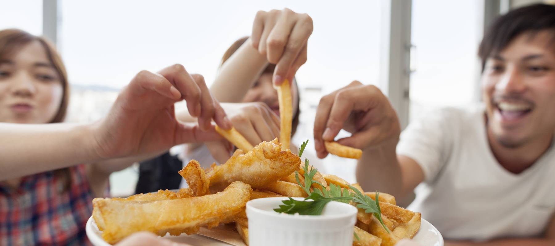 People sharing appetizers at a restaurant.