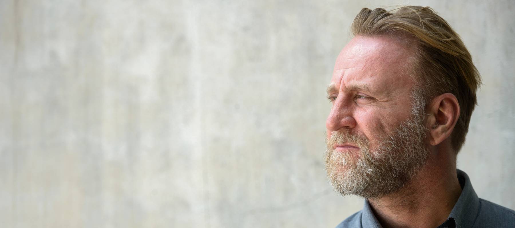 Worried middle-aged male looking off to the side.