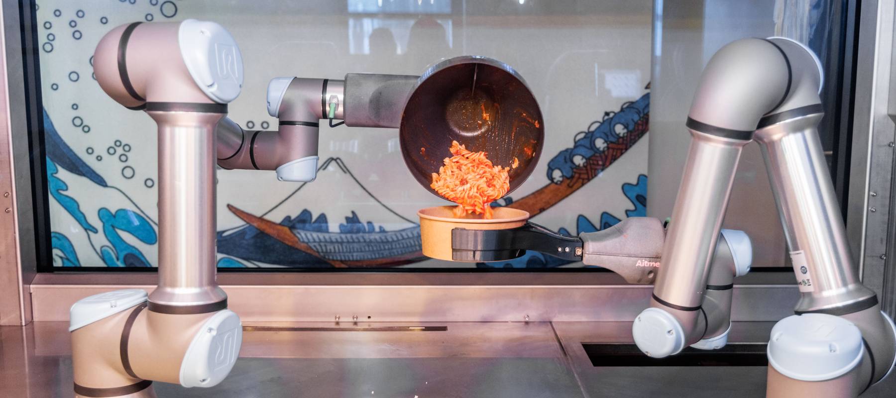 A robot fills a finished dish into a bowl in Gromitz, Germany, July 20, 2023.