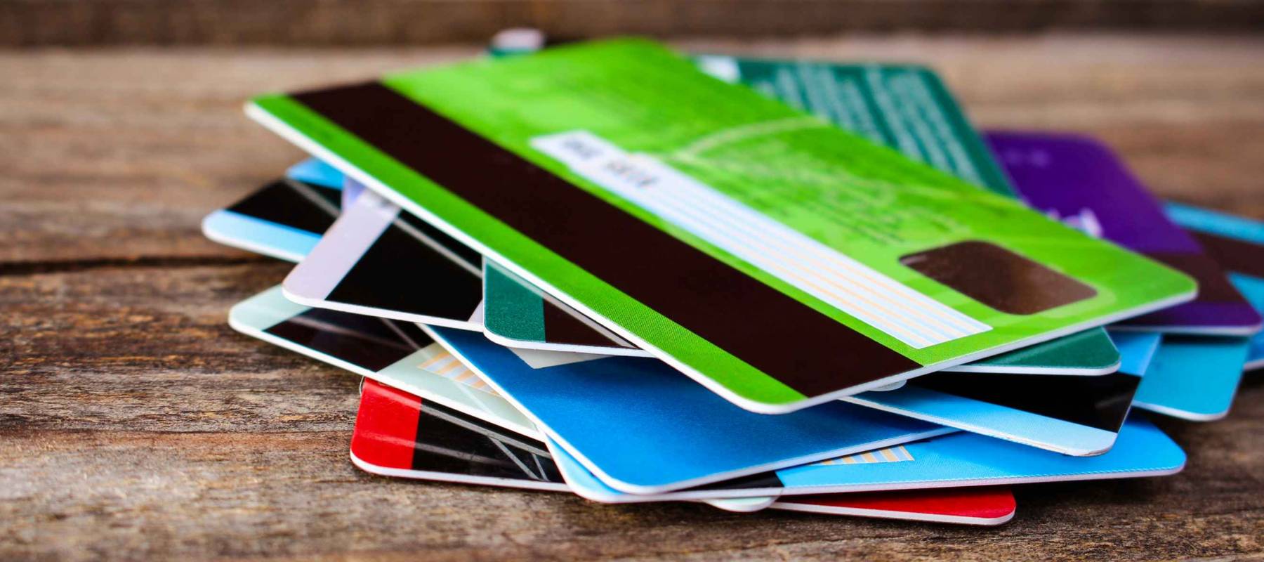 Credit card on wooden background.