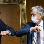 Federal Reserve Chair Jerome Powell bumps elbows with a colleague during a Senate Banking Committee hearing on Capitol Hill, December 01, 2020.