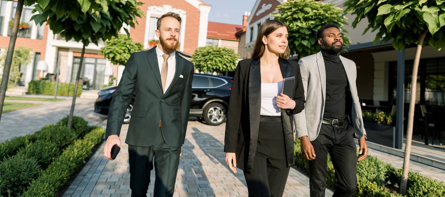 Real estate investors tour a new build suburb.