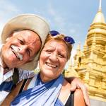 A couple taking a selfie in front of golden temple in Ko Samui.