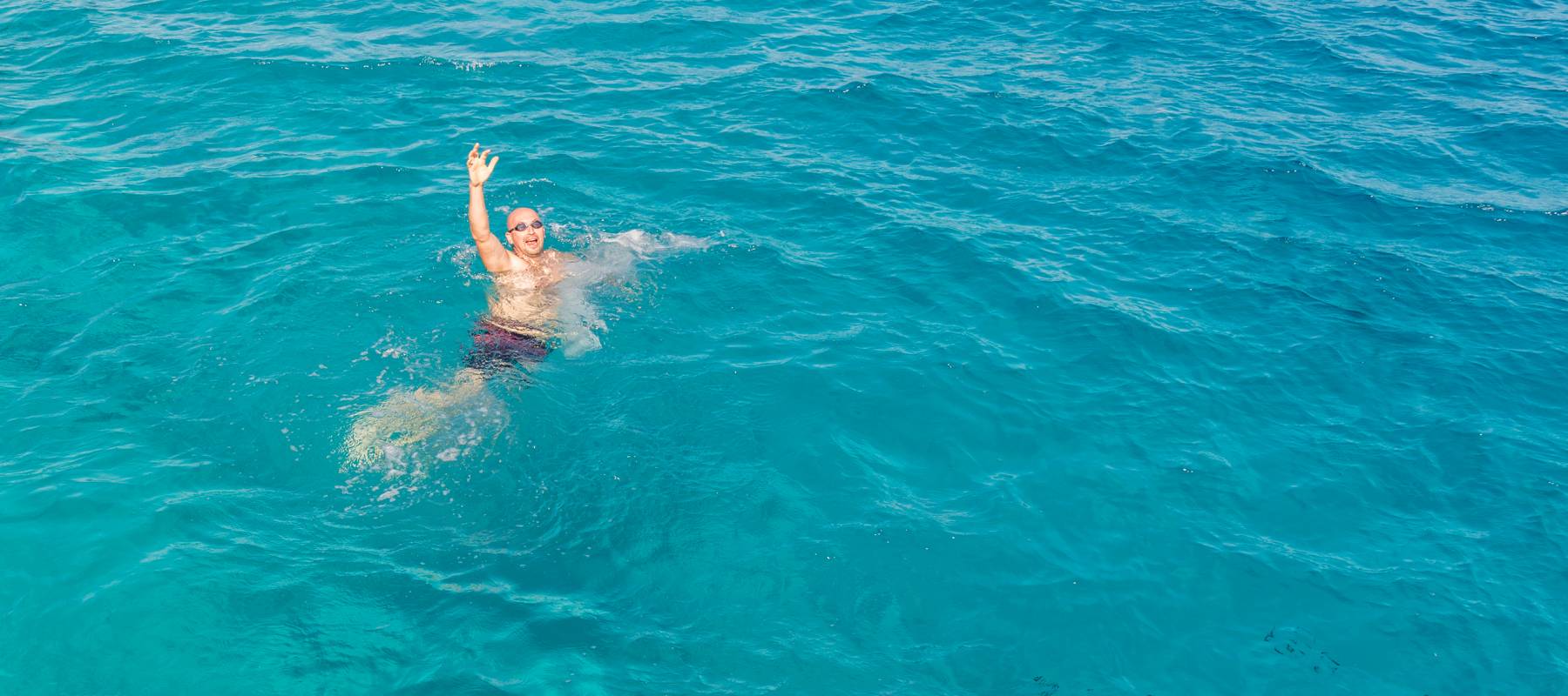 A man treads water, drowning in debt.