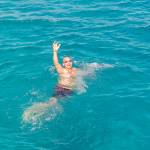 A man treads water, drowning in debt.