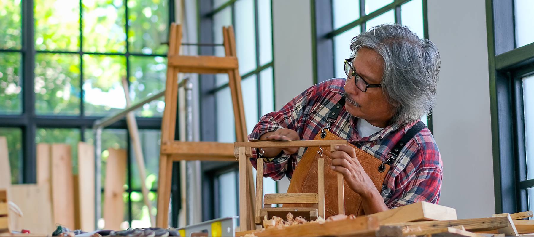 Older gentleman working in a woodshop.