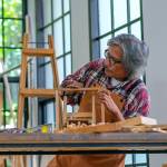 Older gentleman working in a woodshop.