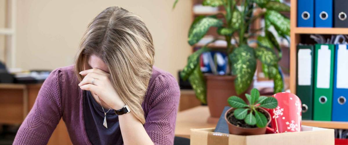 Upset with dismissal woman crying in the workplace