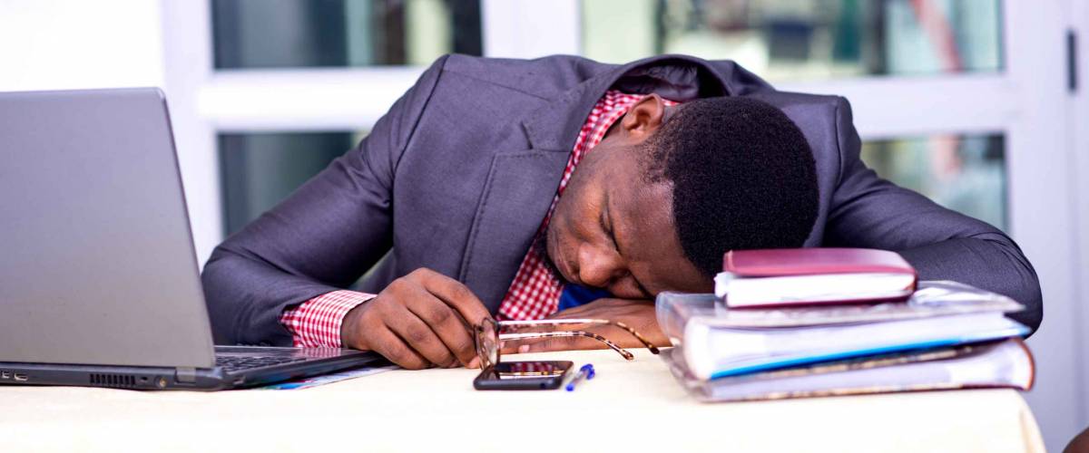 handsome businessman in suit sitting at desk while sleeping.